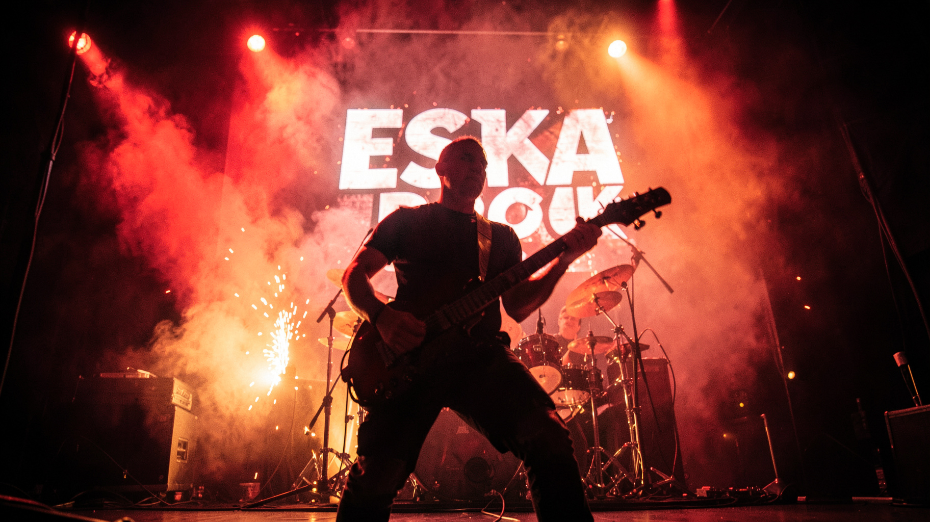 A rock guitarist silhouette on a smoky stage beneath a backlit banner reading ESKA ROCK