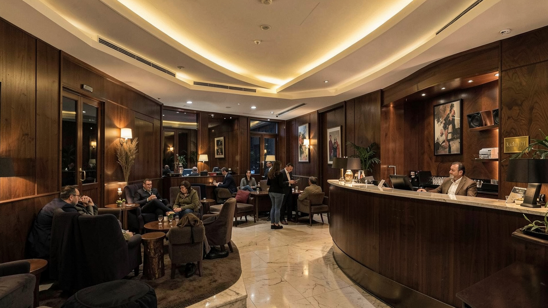 An elegant hotel lobby lounge in Belgrade with a plaque reading Radio 101