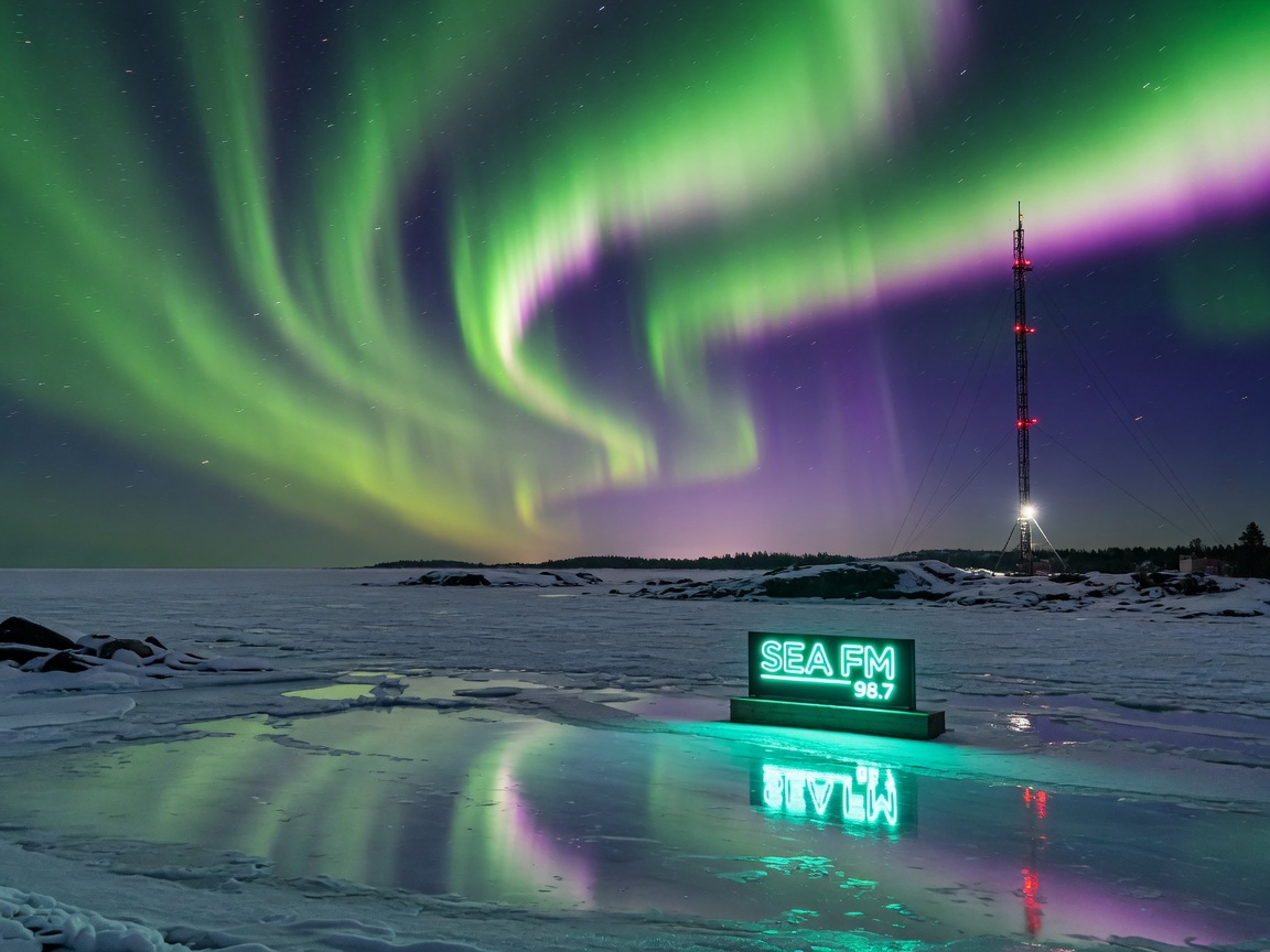 The aurora borealis over a frozen sea coastline near Oulu, Finland, representing Sea FM Radio's Arctic broadcast footprint
