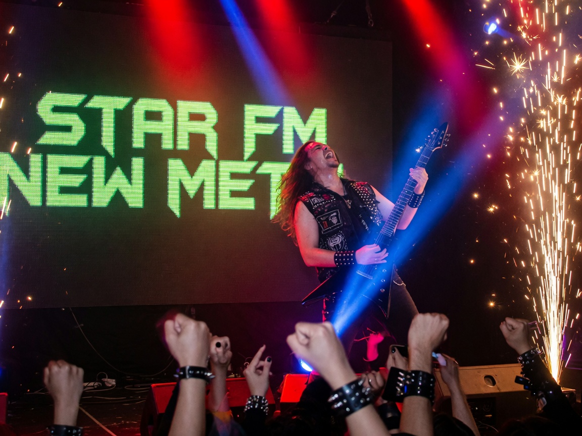 A metal guitarist performing under red stage lighting, representing Star FM's New Metal livestream