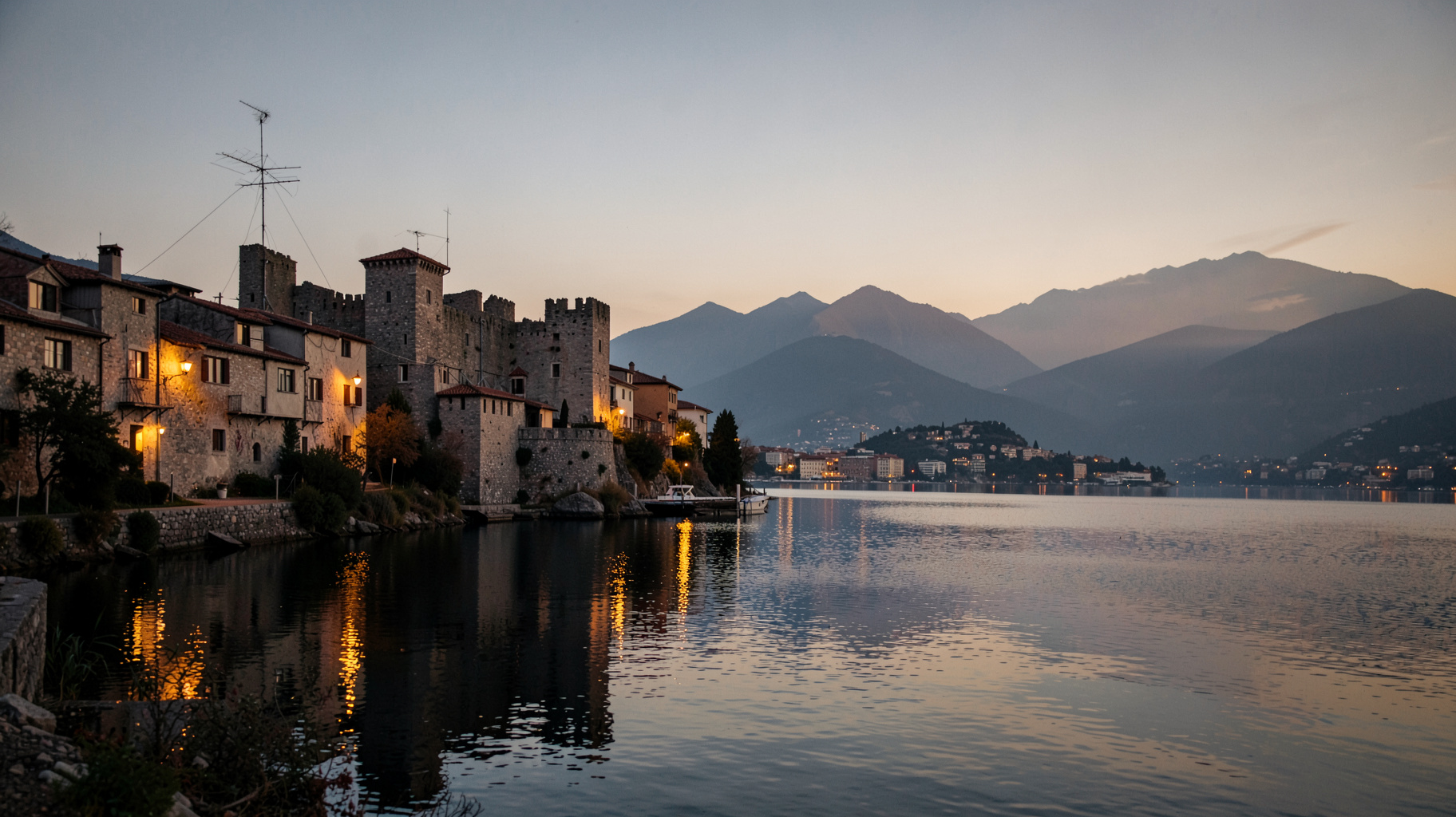 Ioannina's old fortress and Lake Pamvotis at dusk with a radio antenna on a rooftop