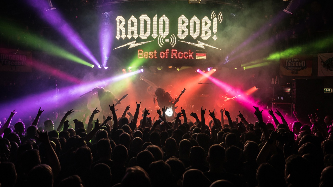 A rock concert crowd silhouetted against stage lighting with a screen reading Radio BOB Best of Rock