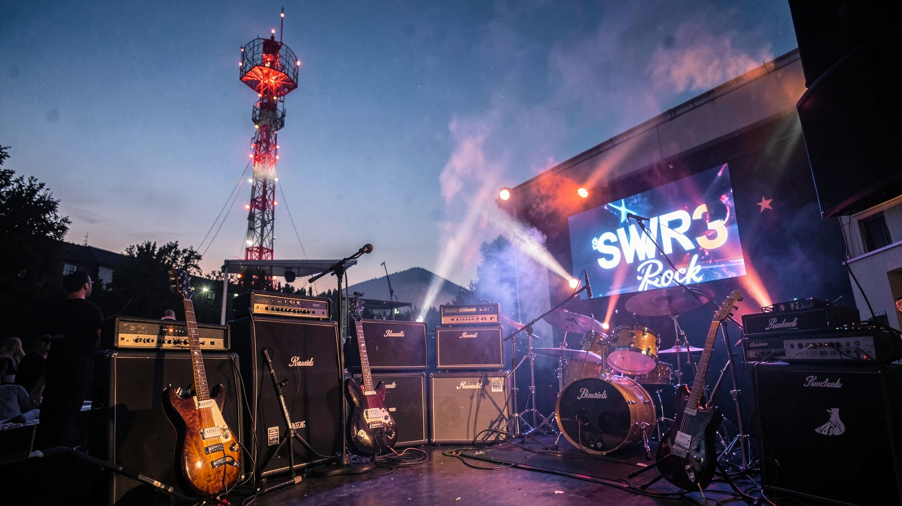 A German radio tower at dusk with electric guitars in the foreground and a screen reading SWR3 Rock