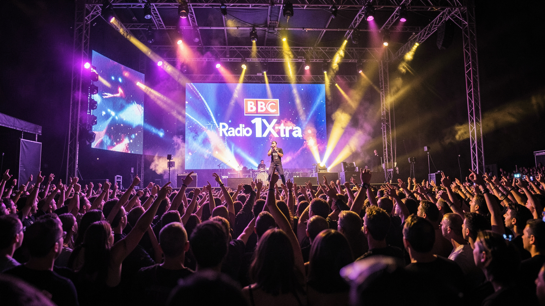 A packed UK arena concert with a BBC Radio 1Xtra stage backdrop