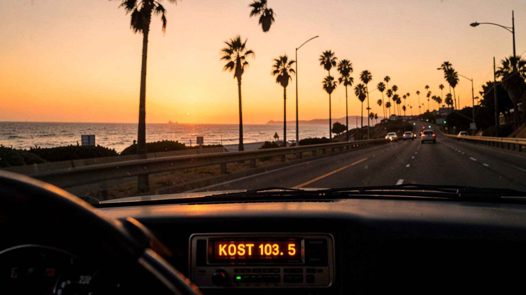 Golden hour Pacific Coast Highway with a car radio dashboard glowing KOST 103.5